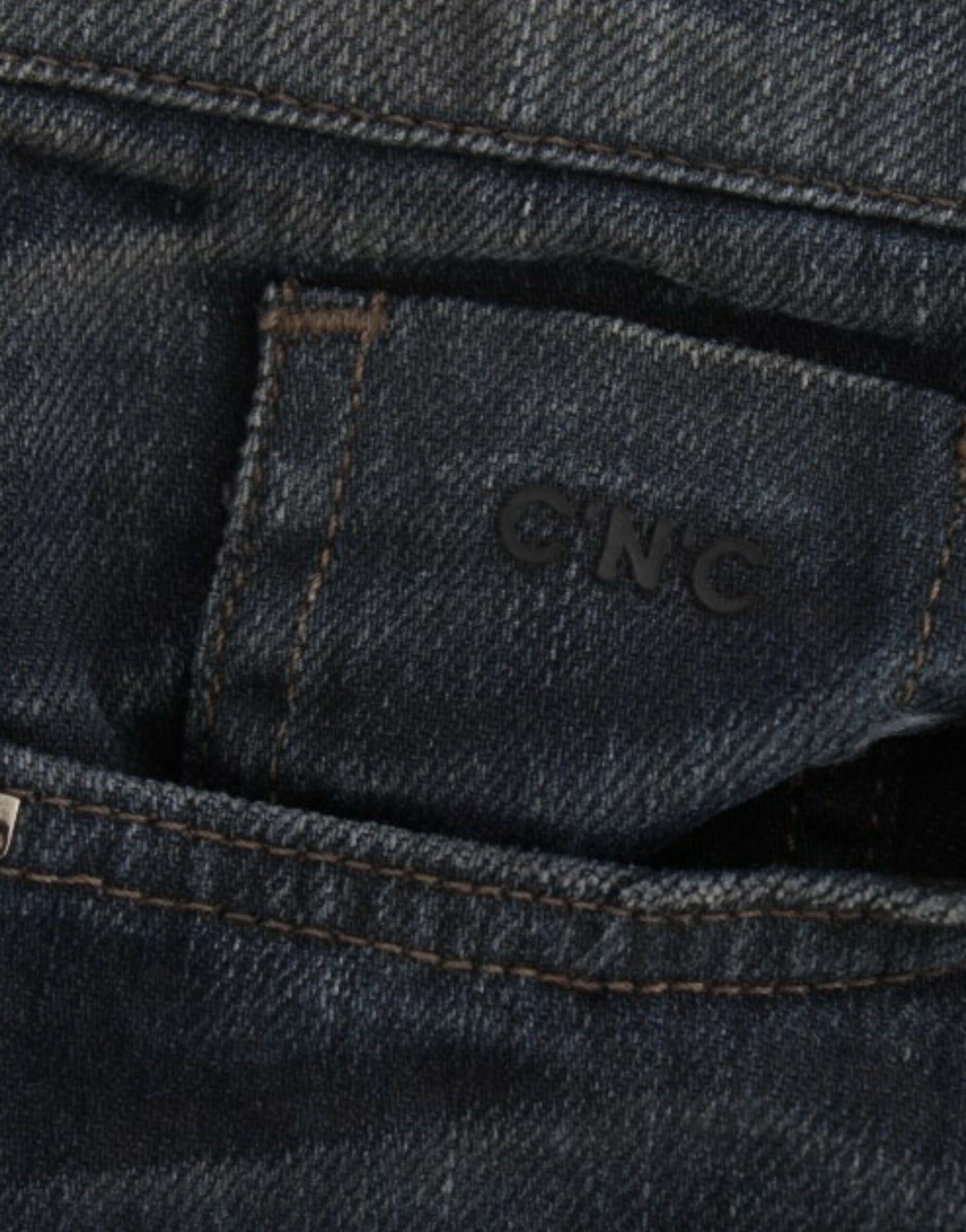 Blue denim jeans with a visible logo on the back pocket