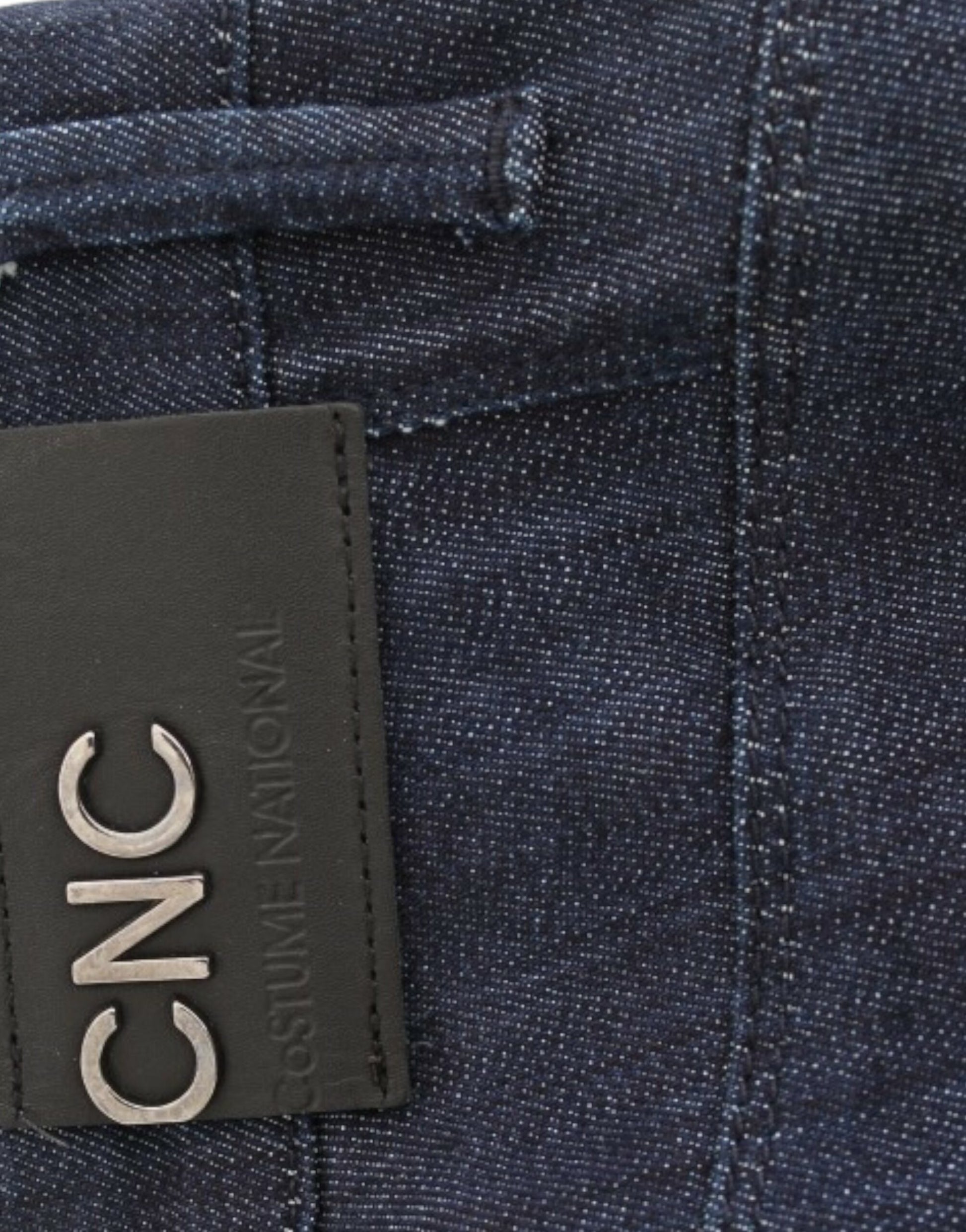 Blue denim jeans with a black leather tag on the waistband