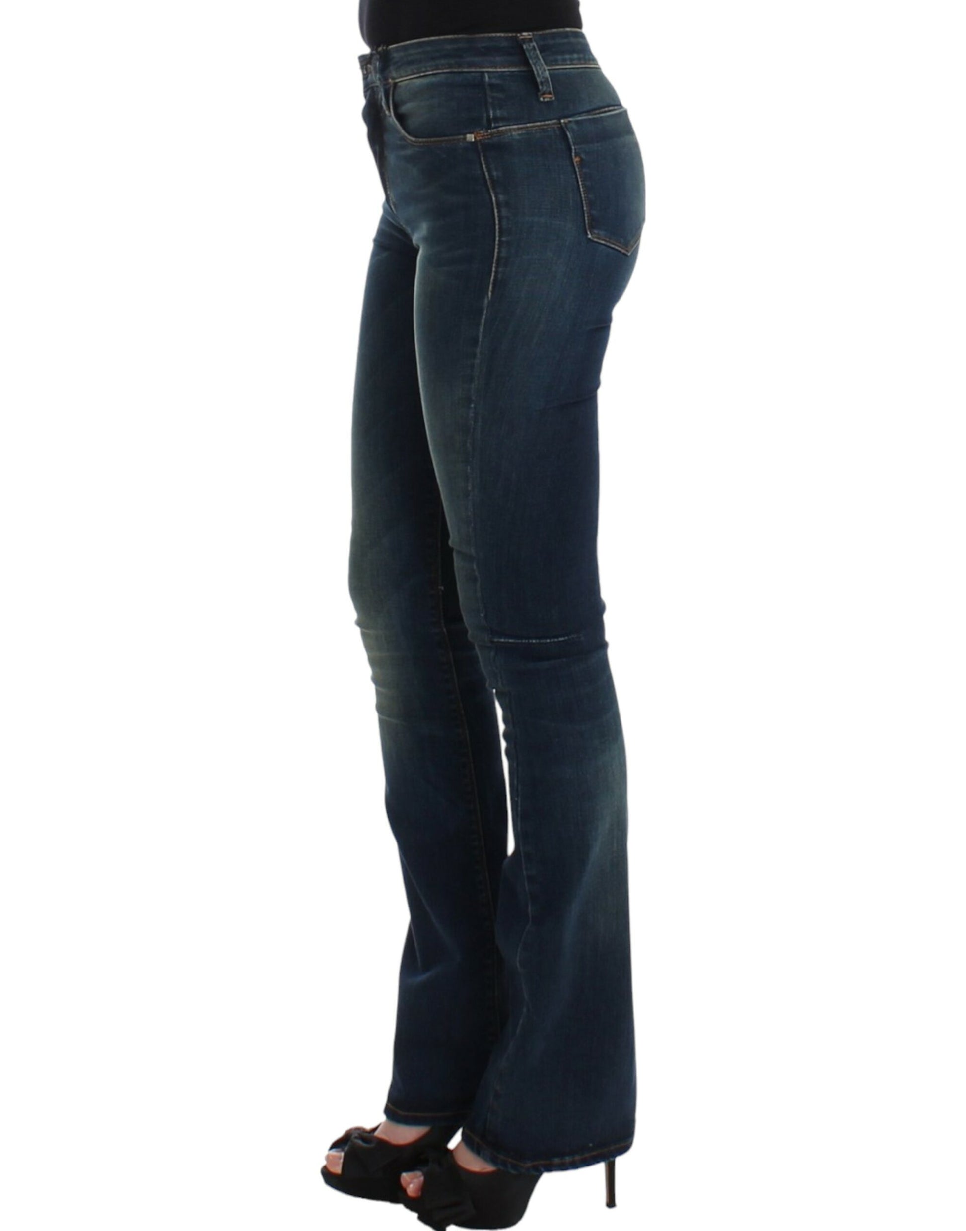 Woman wearing blue jeans with flared legs and black high heels