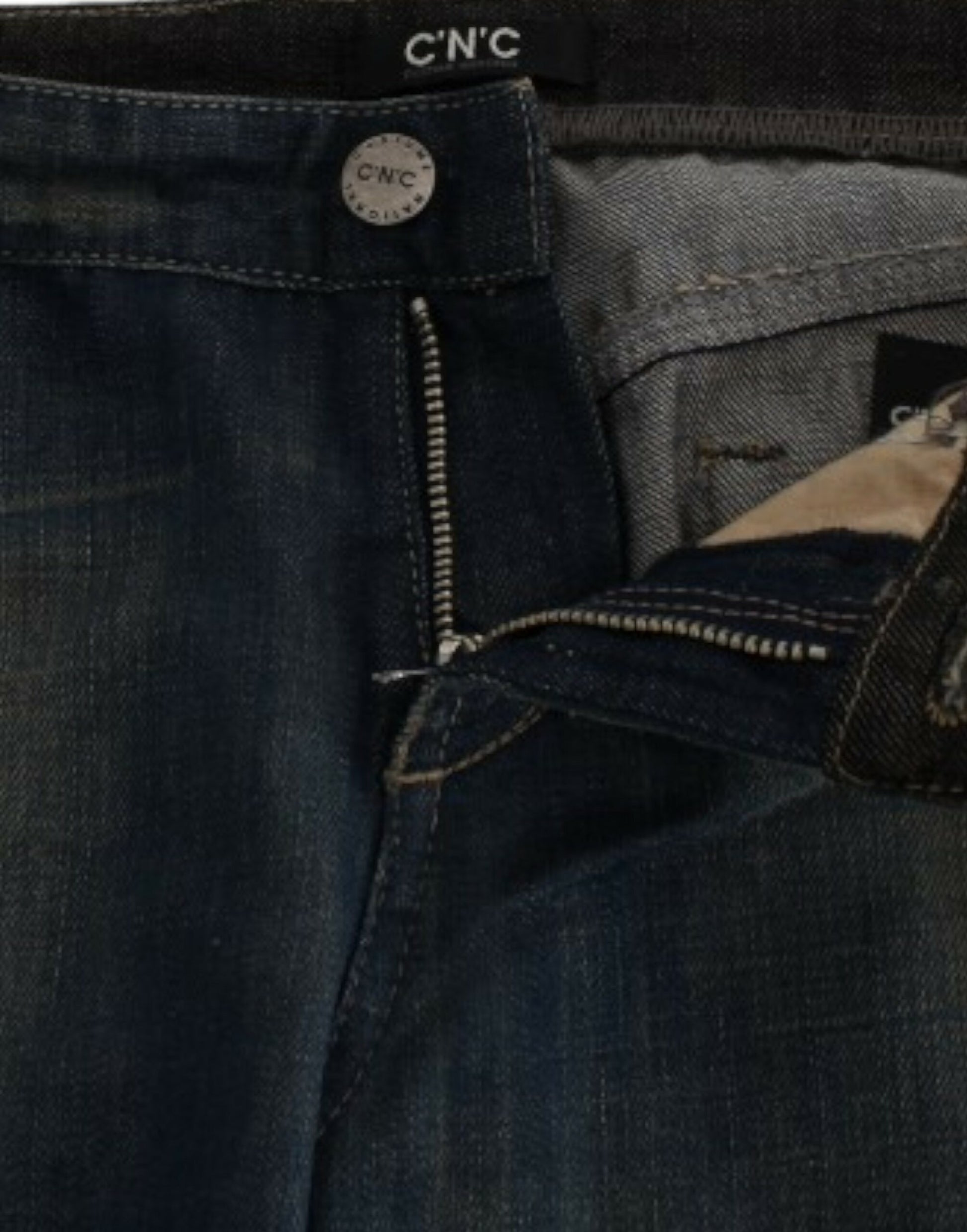 Pair of blue jeans with zipper fly and button closure