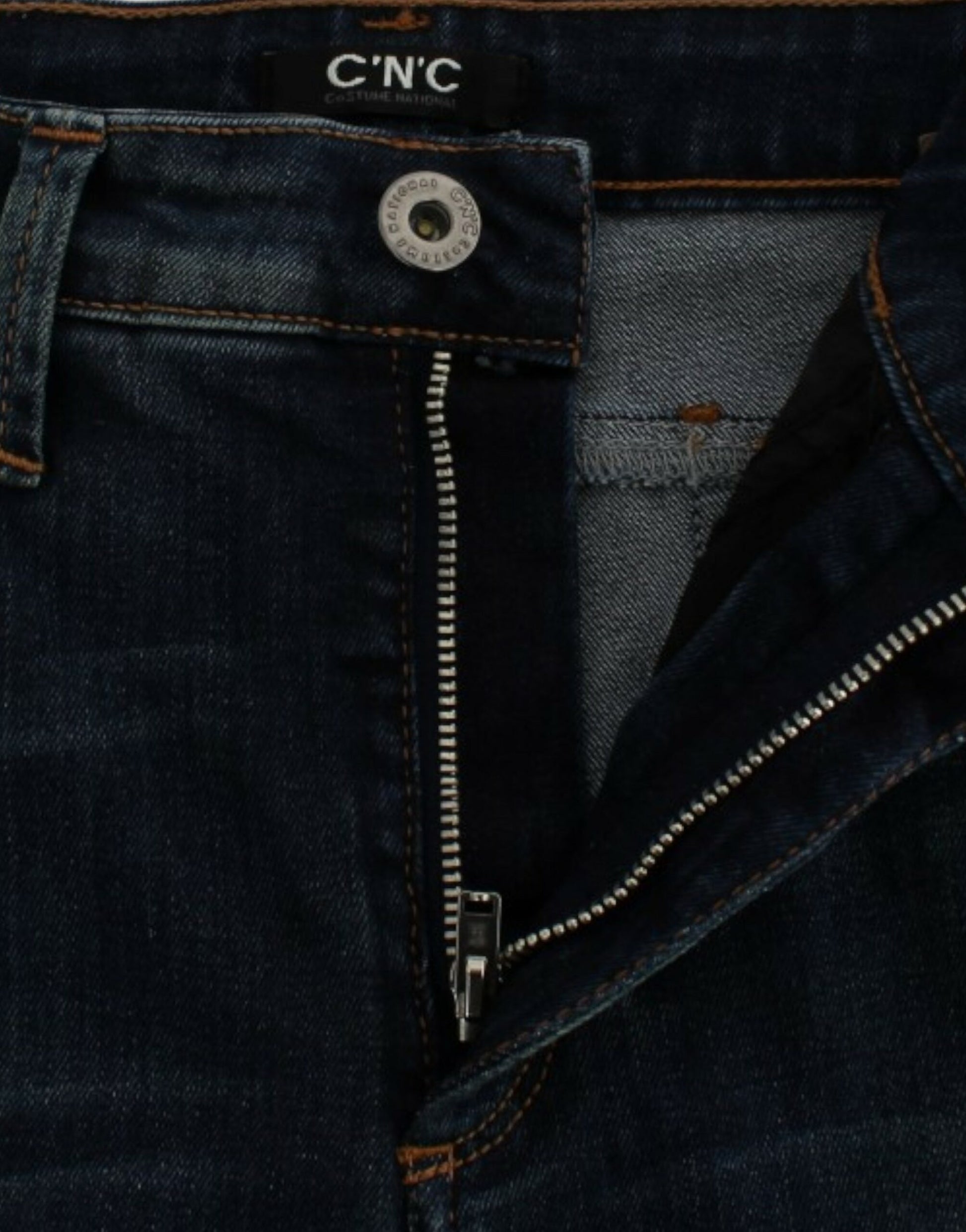Blue denim jeans with zipper and button closure