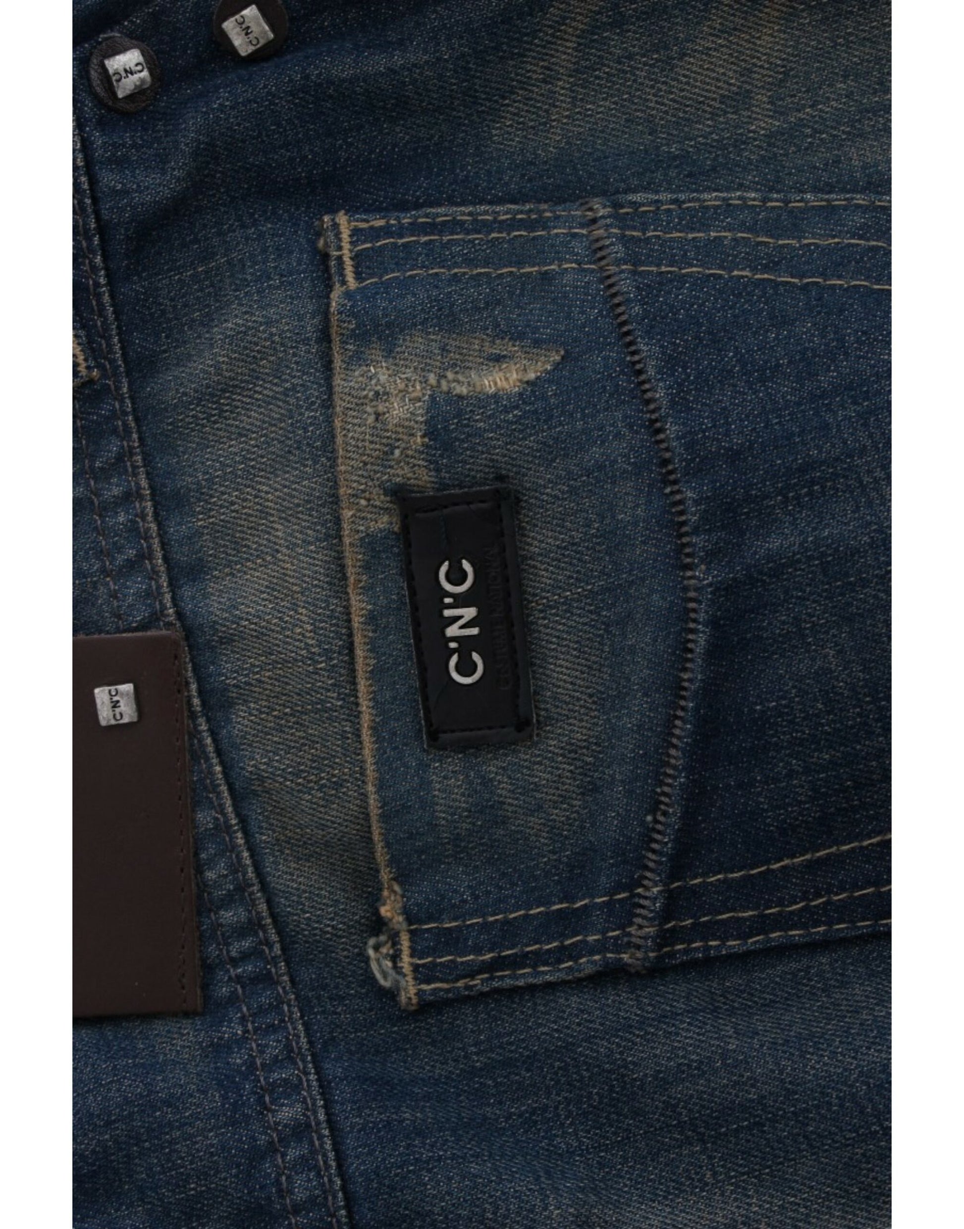 A pair of blue jeans with visible stitching and a brand label on the right side of the waistband