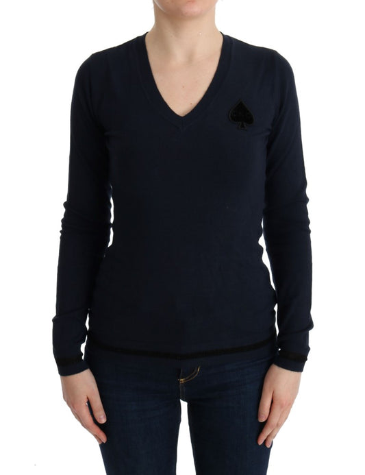 Woman wearing dark blue sweater with a card symbol on left chest