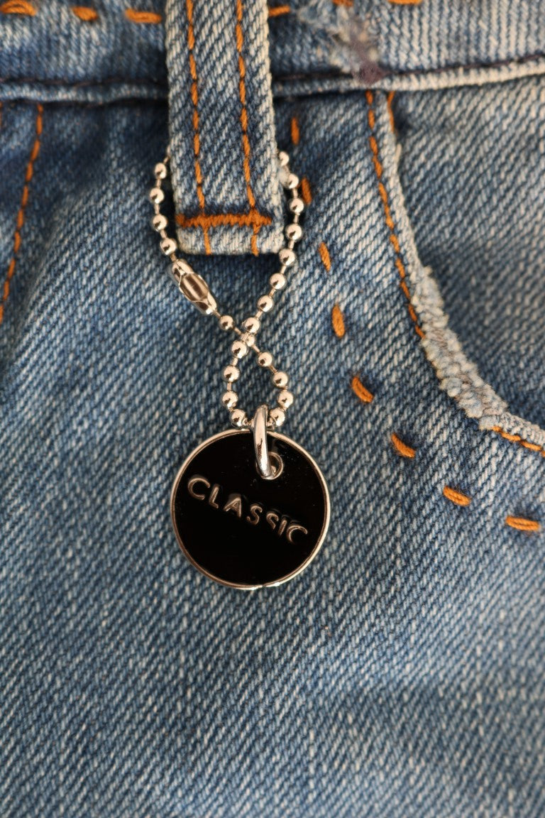 Silver necklace with black pendant reading "classic" on denim jeans