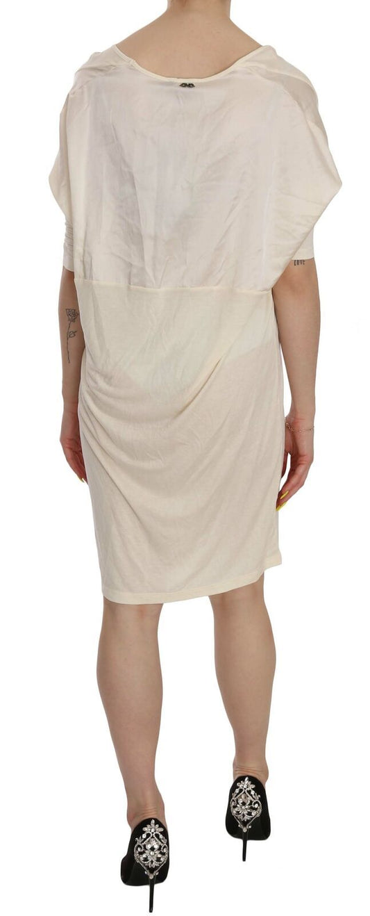 A knee length dress with a round neckline, worn by a mannequin