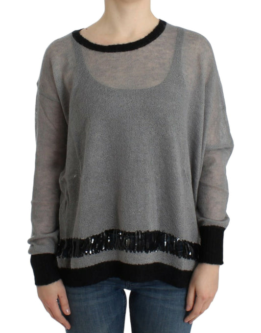 Long sleeve knit sweater with fringe detailing on neckline