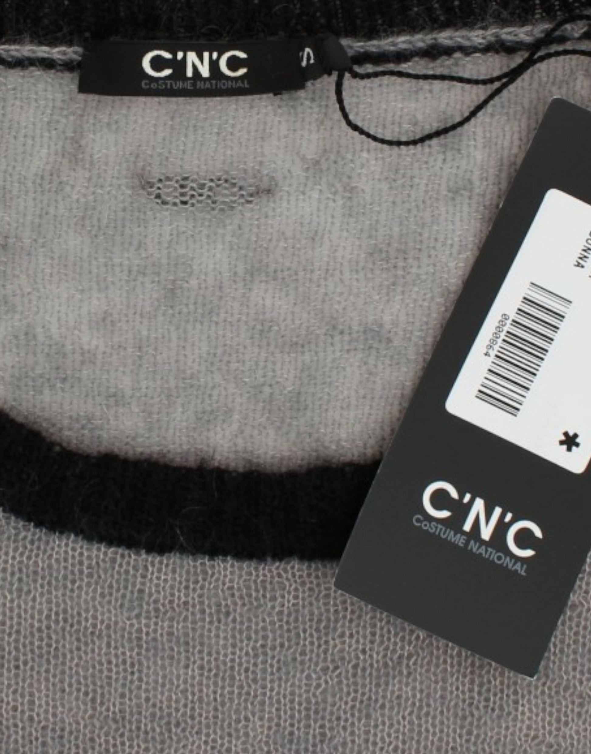 Clothing tag on a gray fabric item