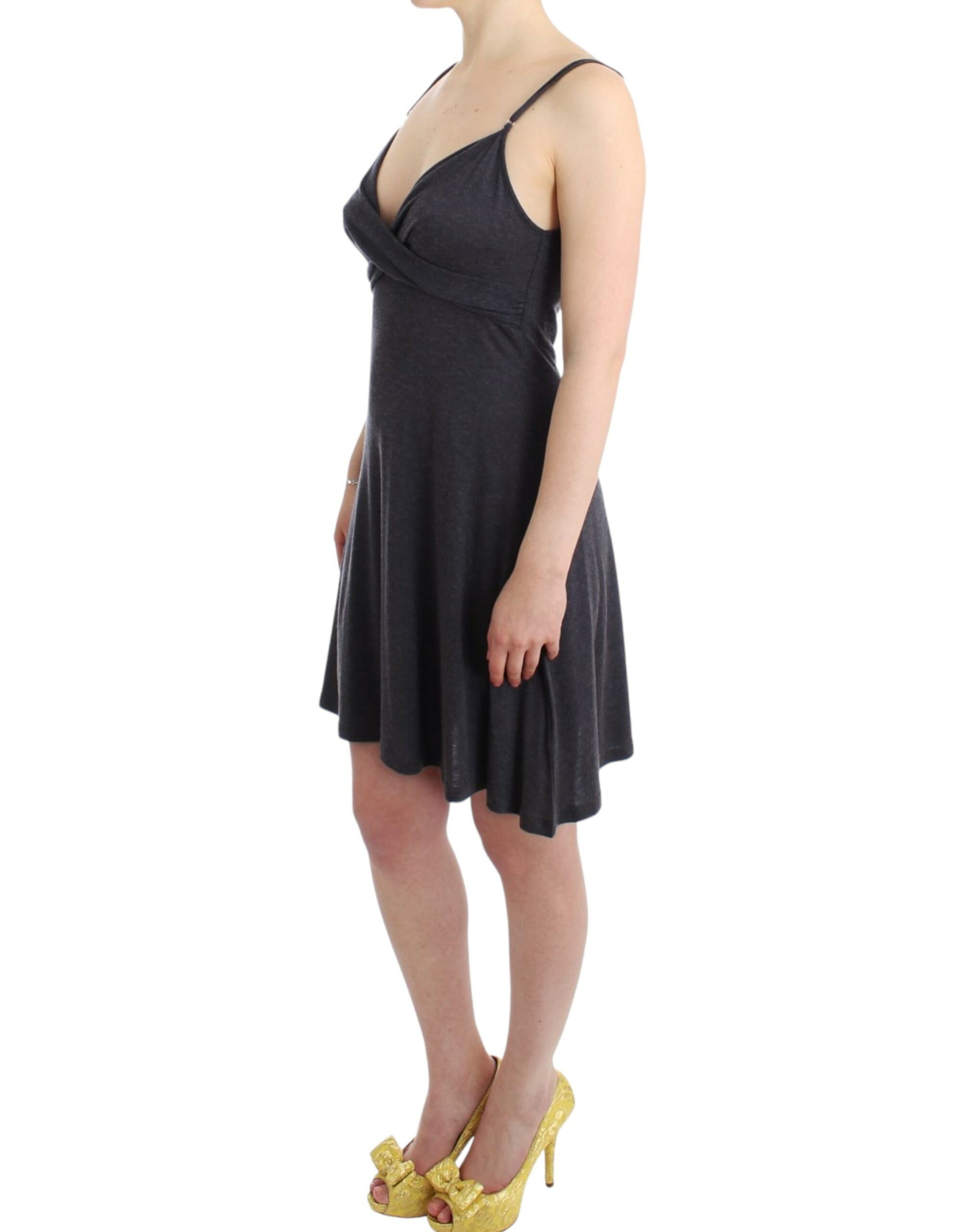 Woman wearing black dress with spaghetti straps and gold high heels