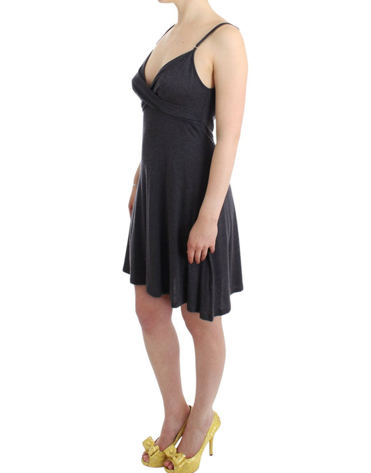 Woman wearing black dress with spaghetti straps and gold high heels