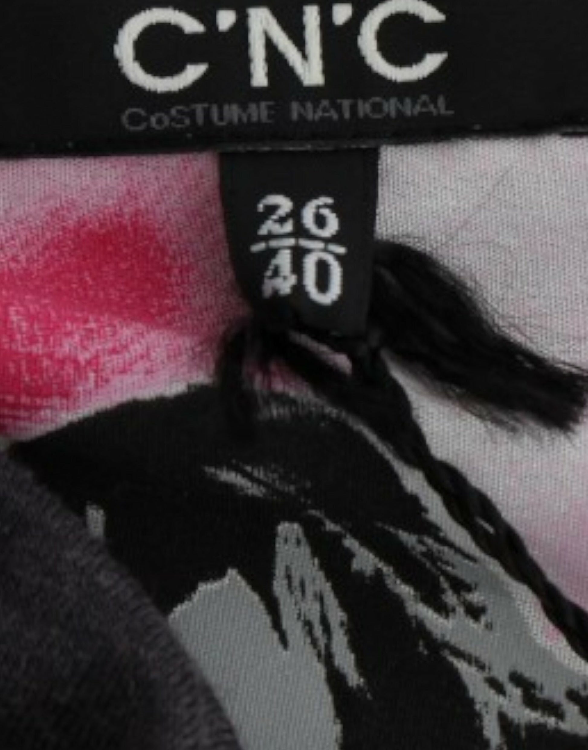 Black tag on clothing with white lettering