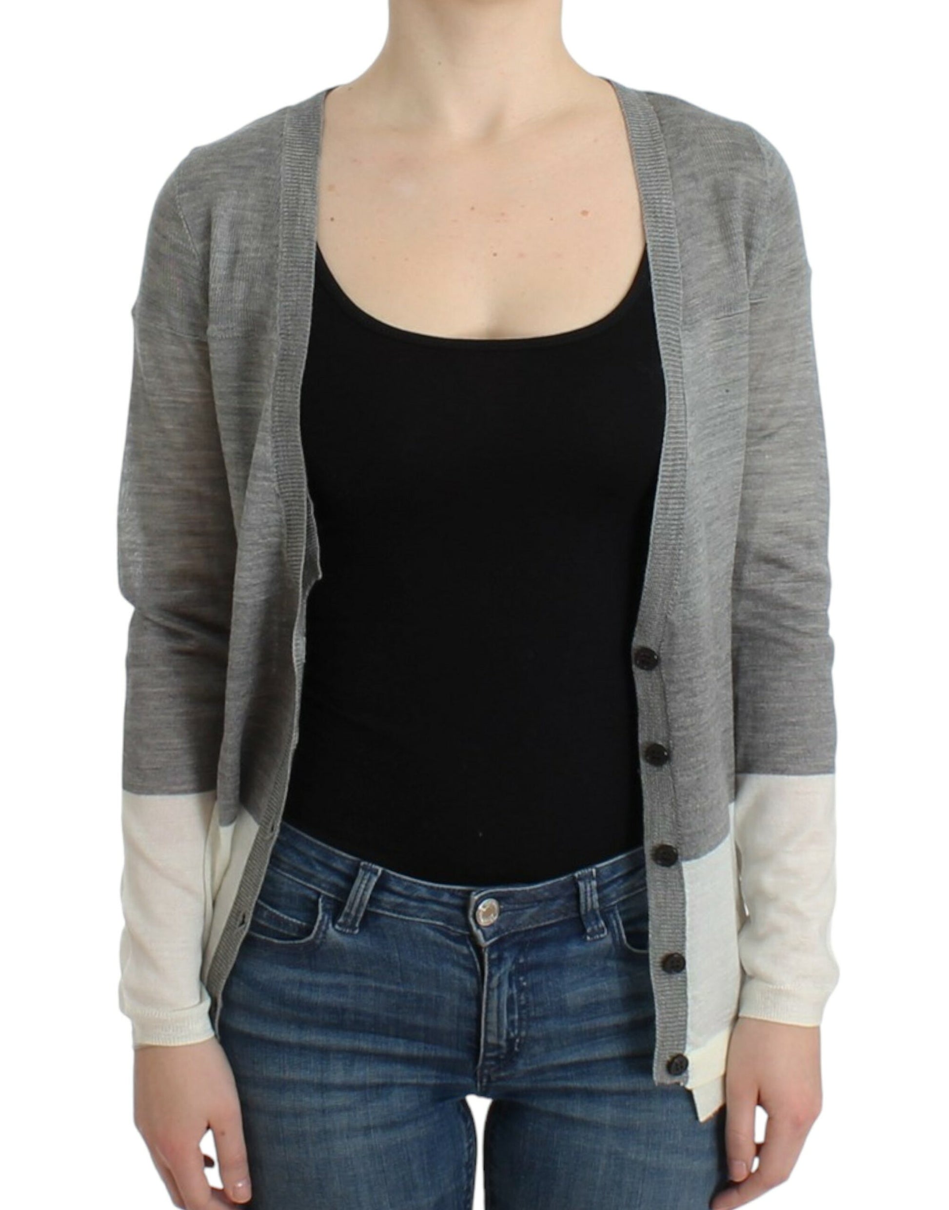 Woman wearing a gray cardigan over black top and blue jeans