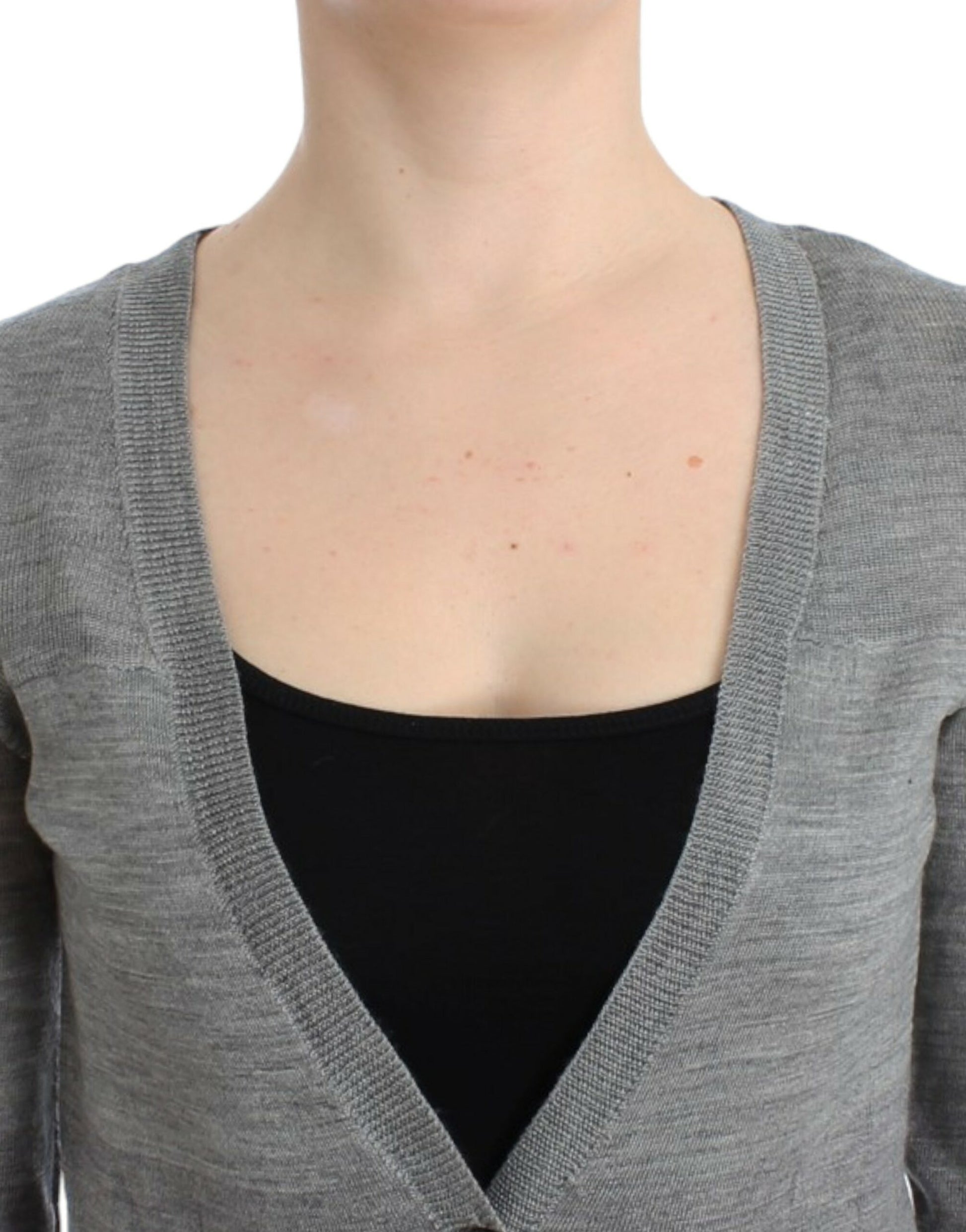 Woman wearing a gray cardigan over black top