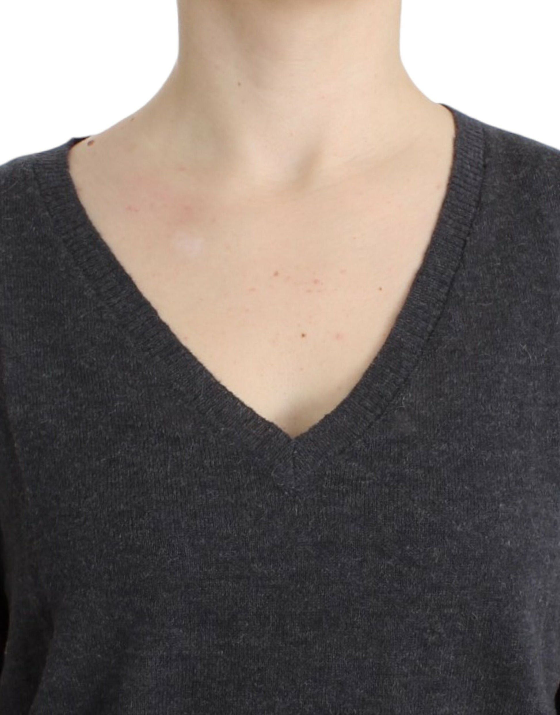 Woman wearing a dark grey V-neck sweater