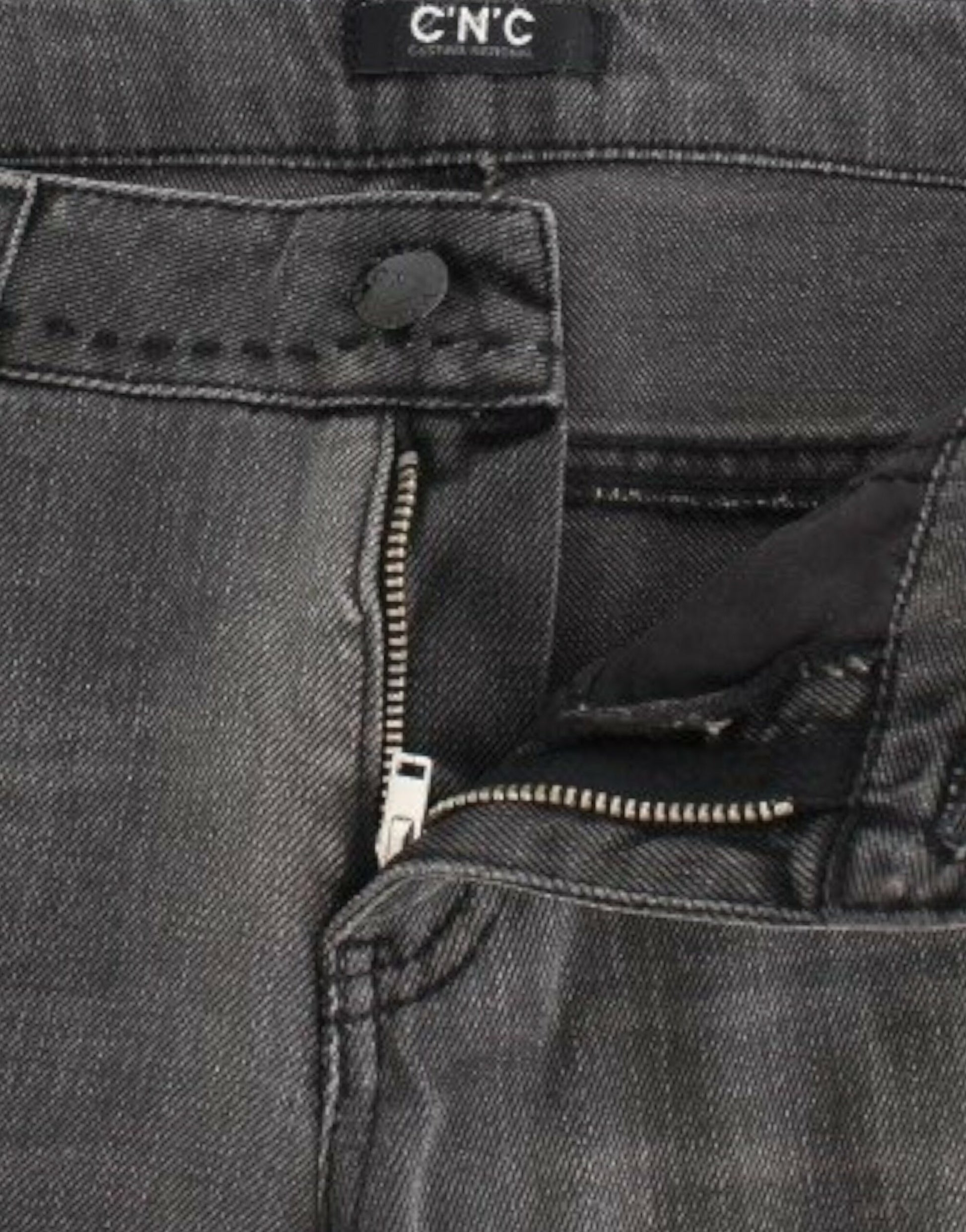 Pair of blue jeans with zipper and button visible on front