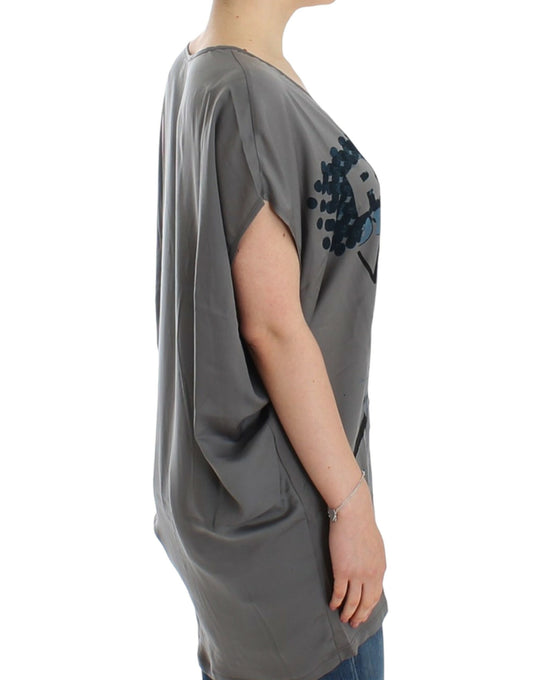 Long sleeved grey dress with embellishments on shoulders