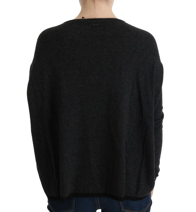 Dark knit sweater worn by person from back view