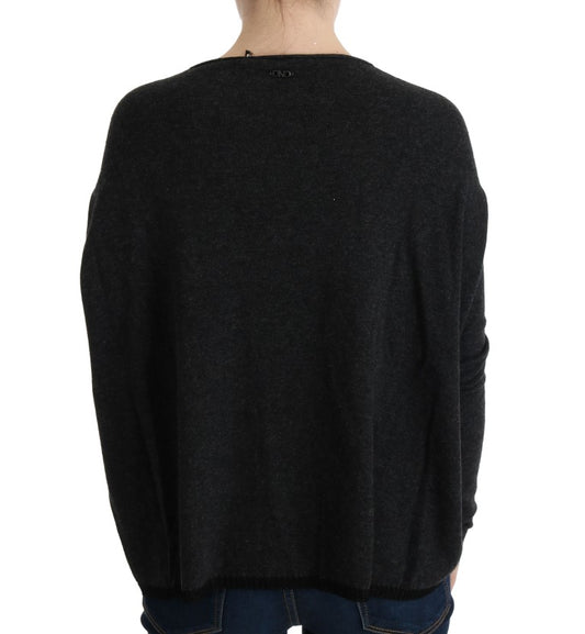 Dark knit sweater worn by person from back view