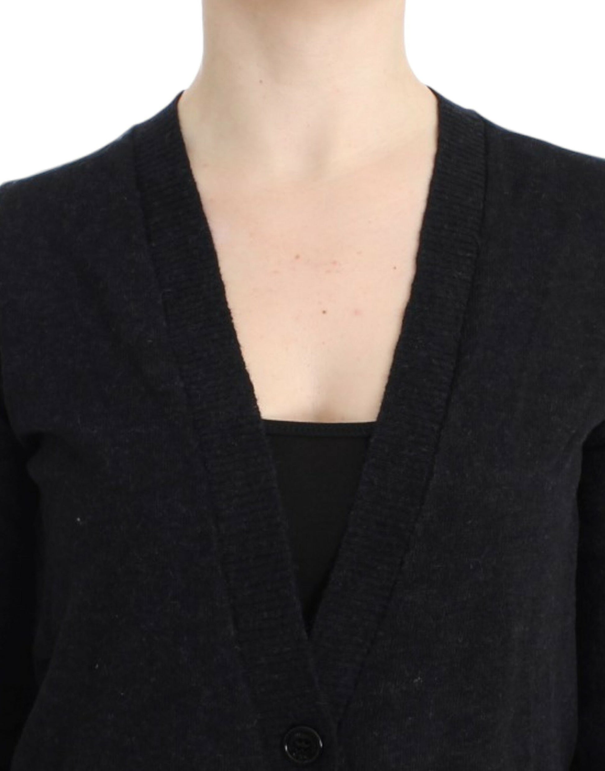 Woman wearing a dark cardigan over a black top