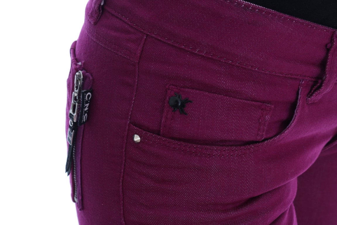 Pair of purple jeans with rips and studs on waistband