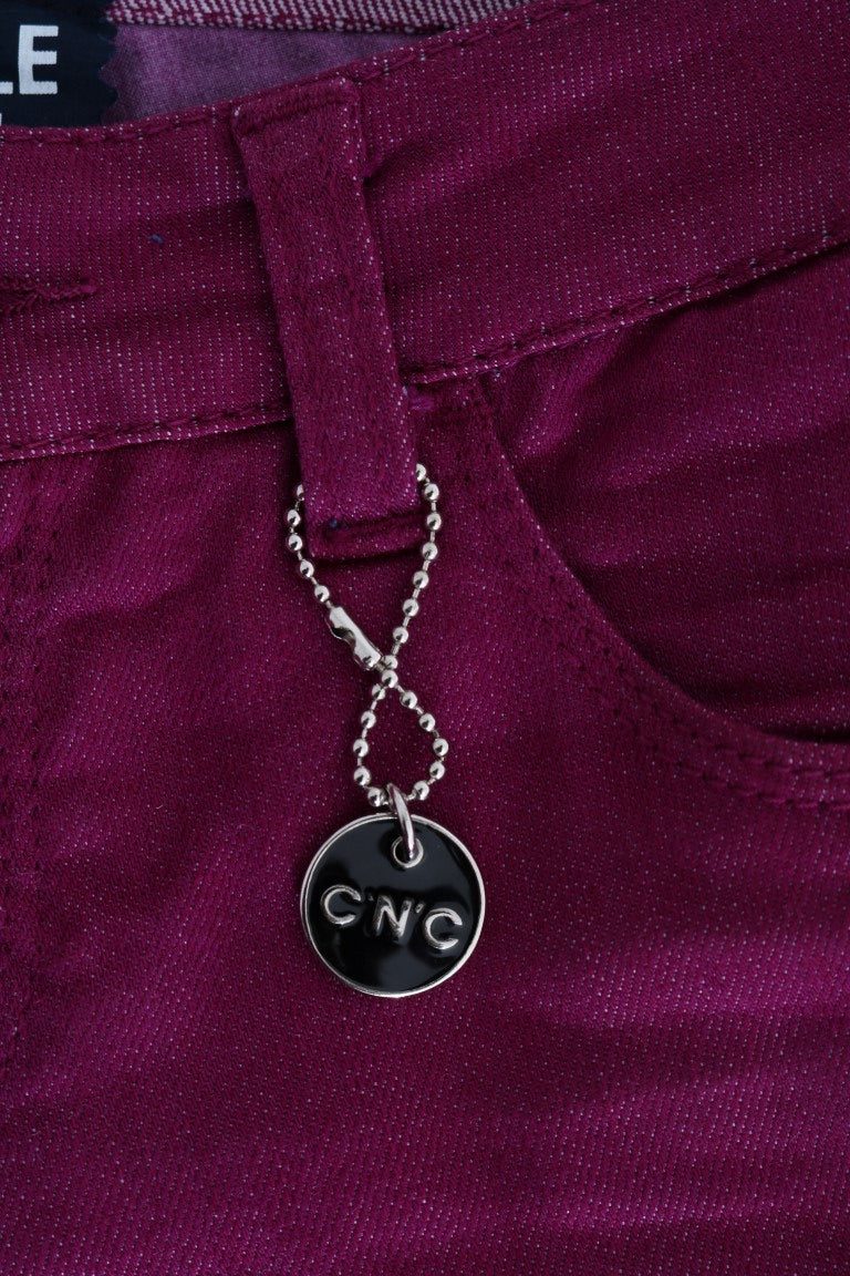 Silver necklace with black pendant on purple fabric