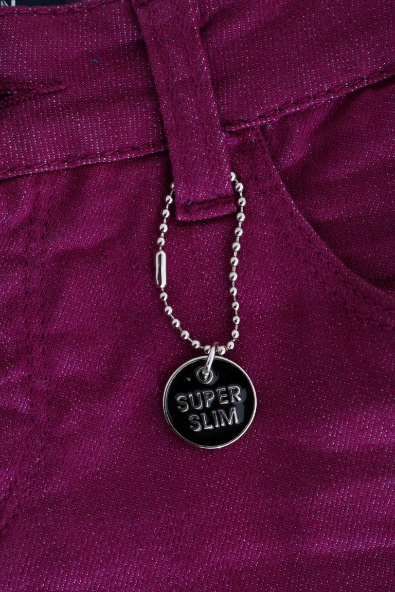 Silver necklace with black pendant on purple fabric