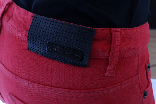 Red jeans with black label on back pocket