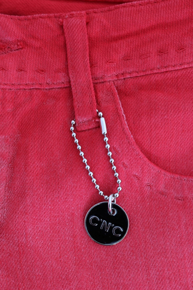 Silver charm on red fabric