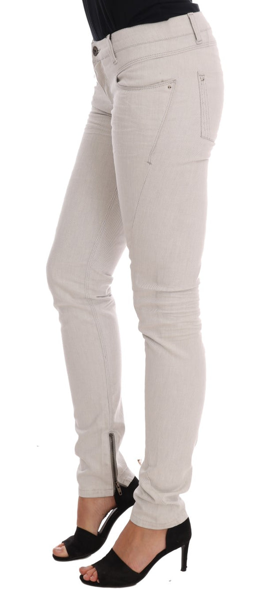 Woman wearing white pants and black heels