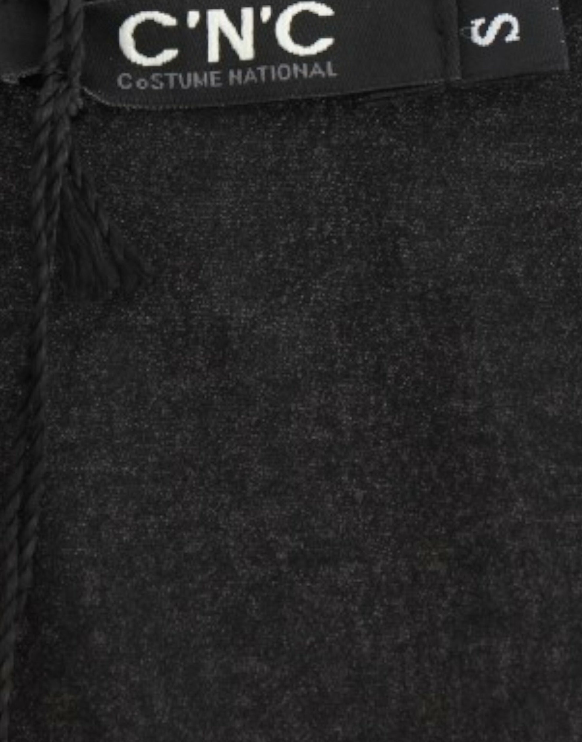 Black fabric with white lettering on tag