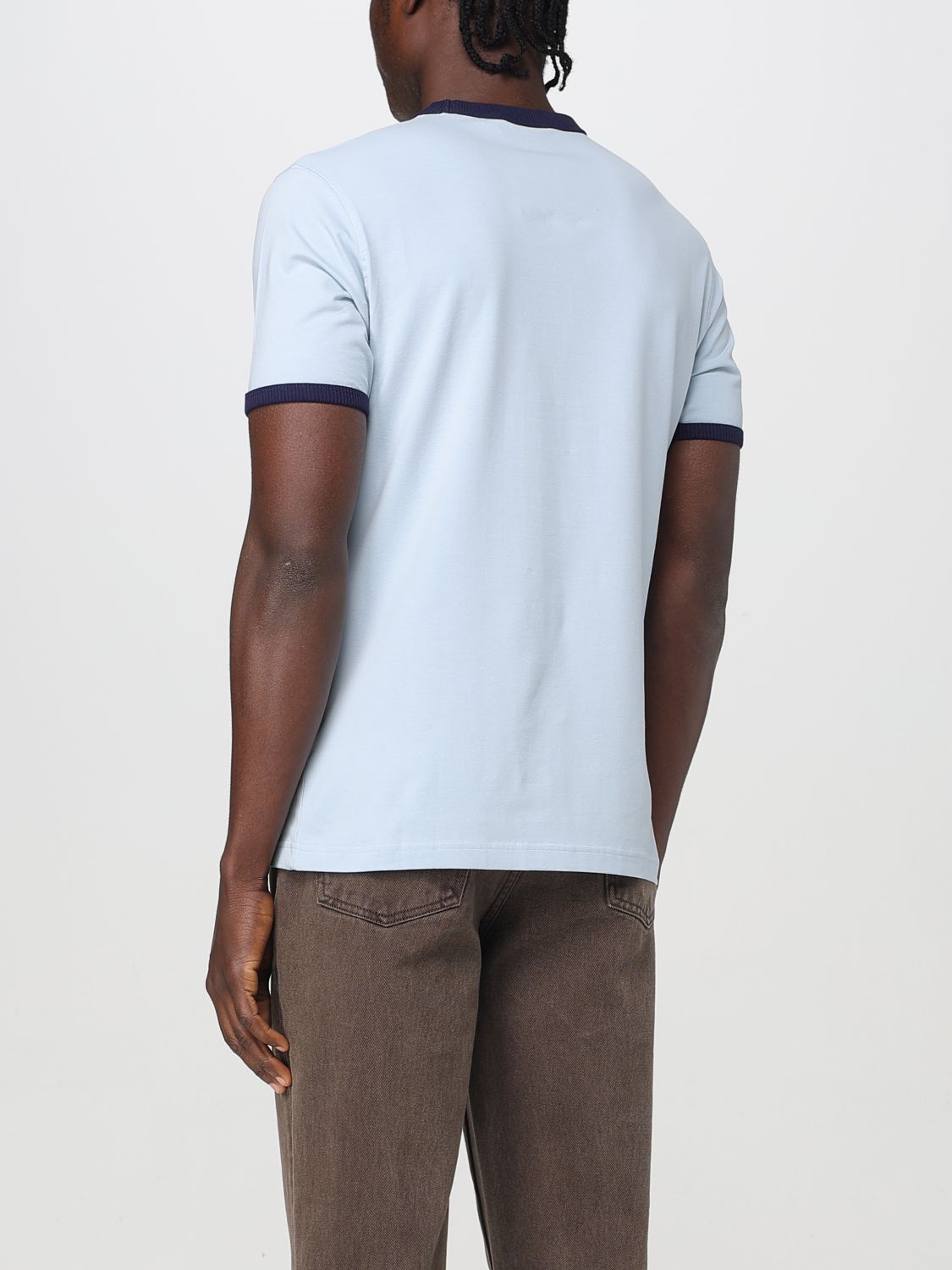 A mannequin wearing a blue cotton t-shirt with white stripes on the sleeves and collar