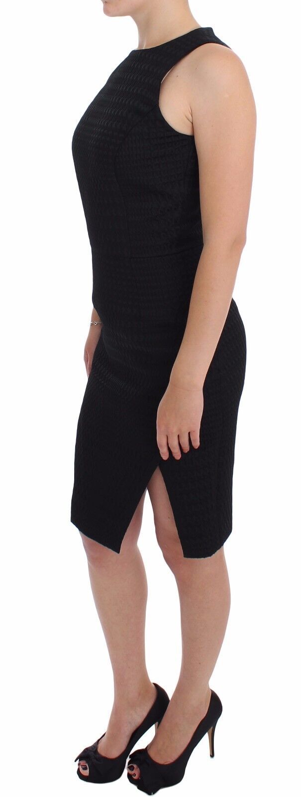 A black knee length dress with a sheer overlay and high heel shoes