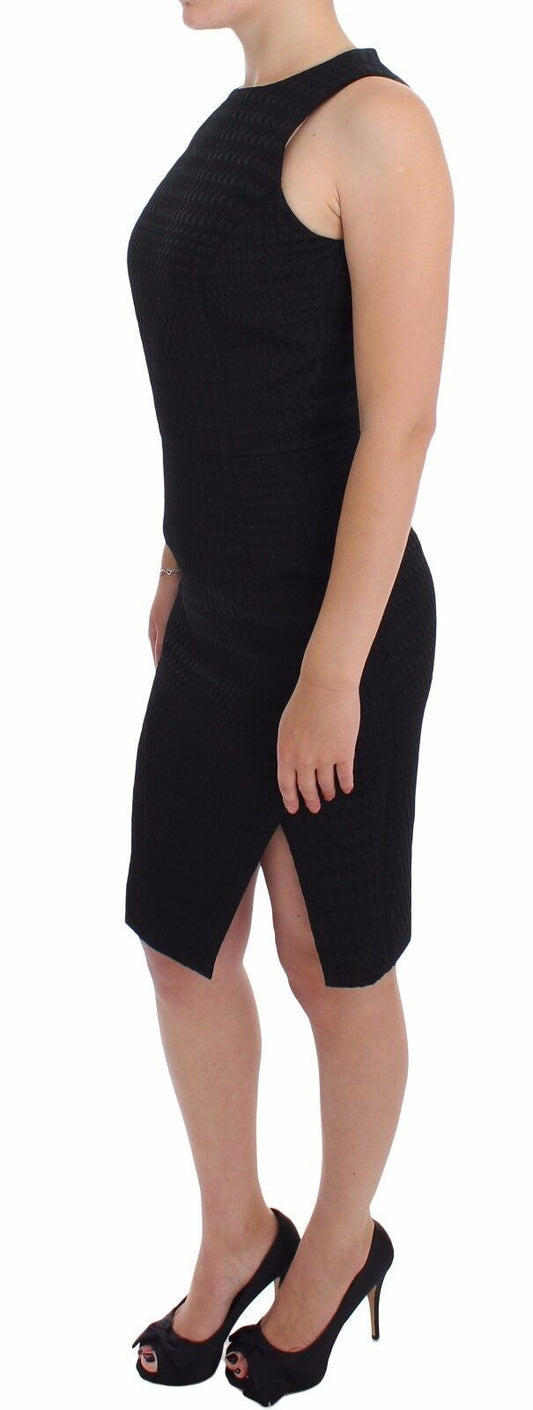 A black knee length dress with a sheer overlay and high heel shoes