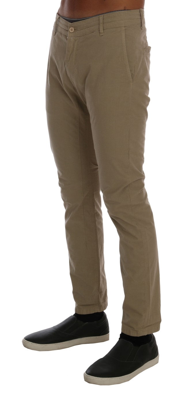 Mannequin wearing khaki pants and black shoes