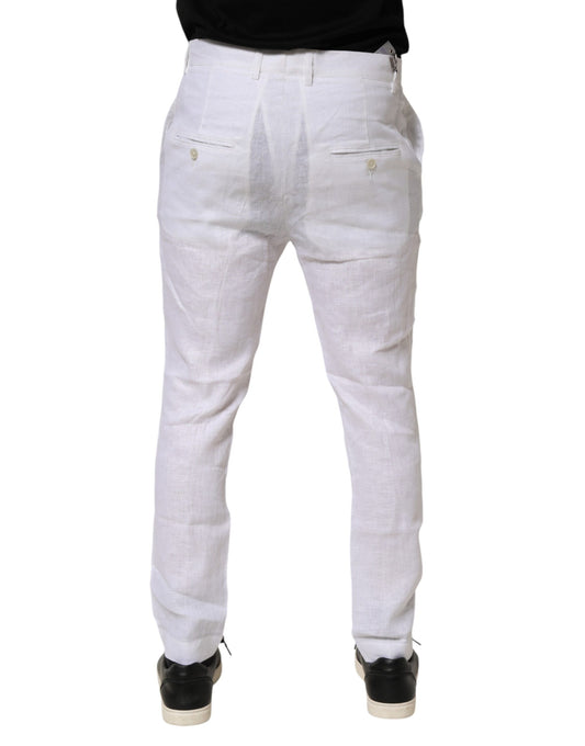 A pair of white linen formal dress trousers with a slim fit and visible stitching
