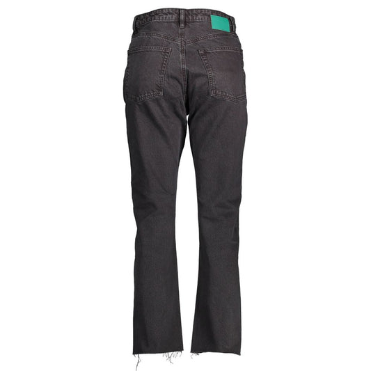 Pair of dark blue jeans with a green tag on the waistband
