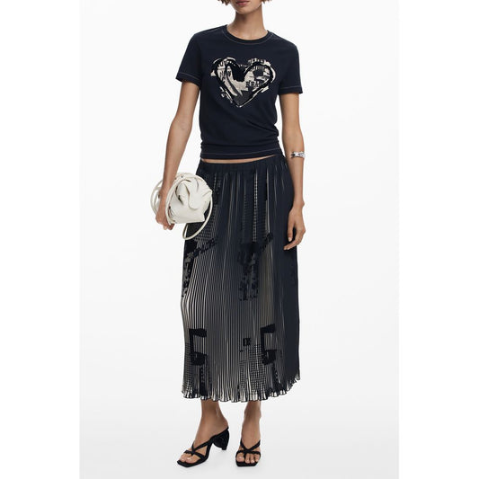 Woman wearing black t-shirt with heart design, skirt, sandals, holding white purse