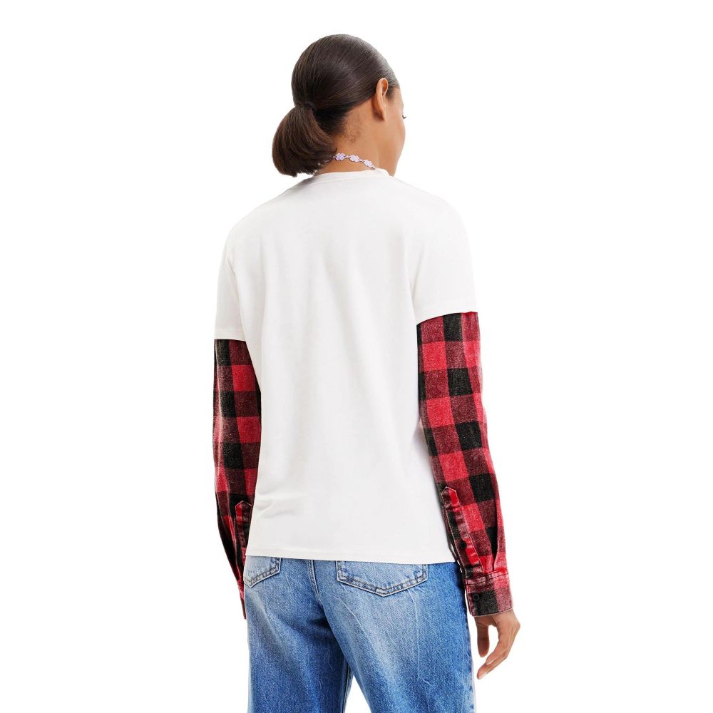 A white cotton t-shirt with a plaid sleeve, worn by a person standing against a plain background