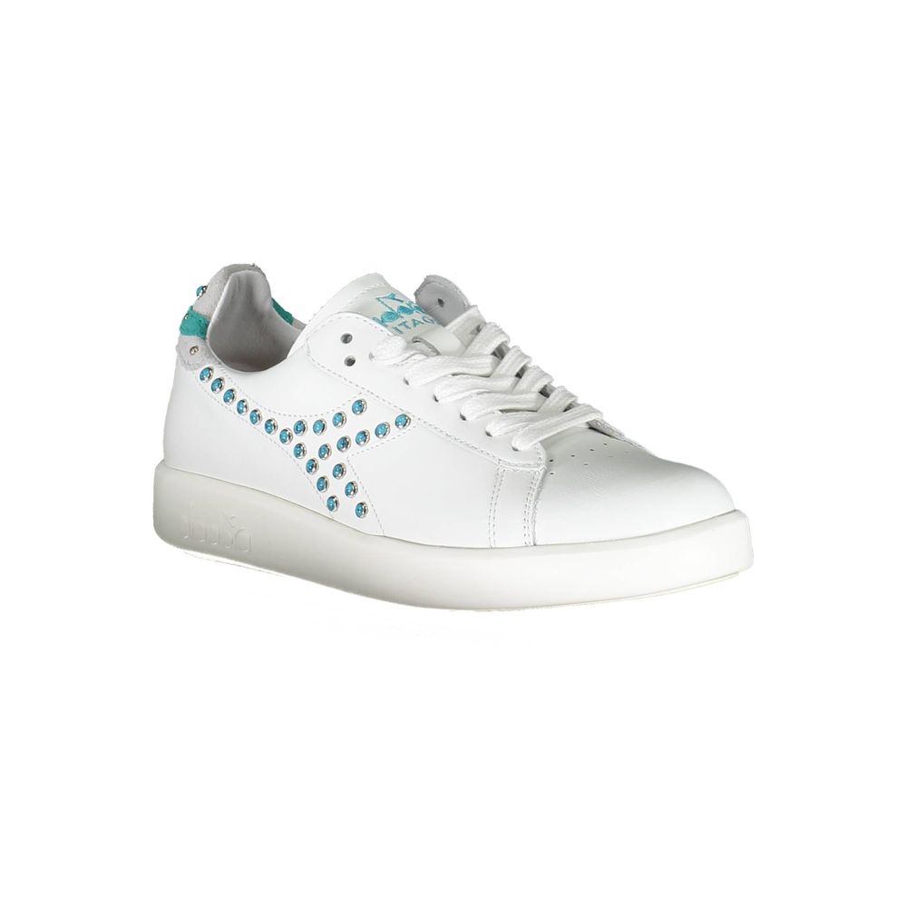 White leather sneakers with blue laces and silver studs on side