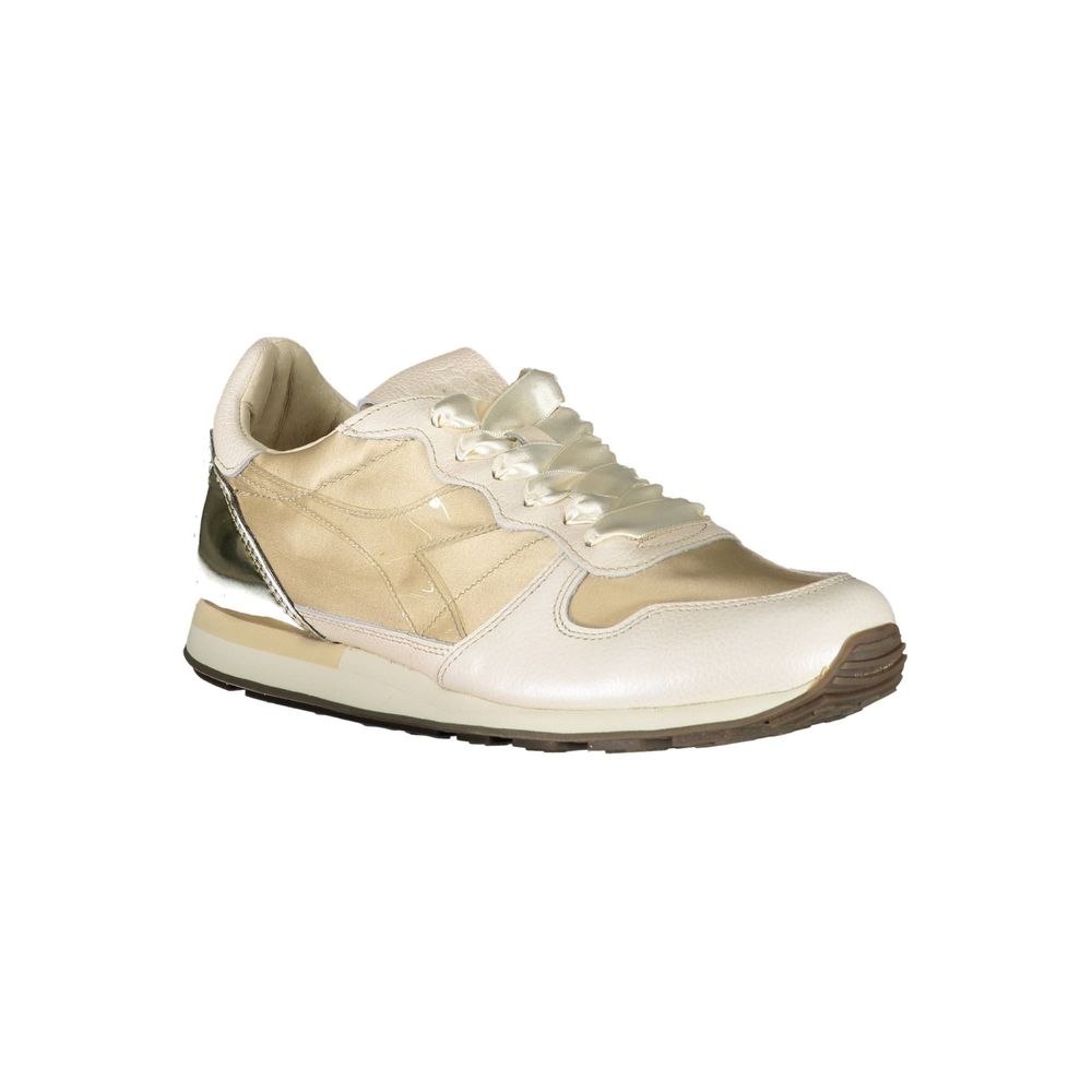 White sneaker with gold accents and laces
