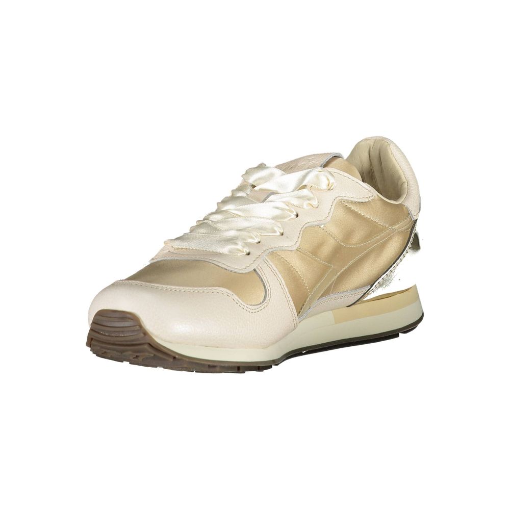 Pair of white and gold sneakers with laces