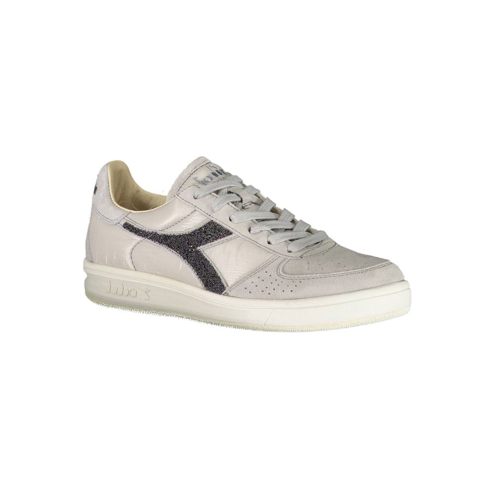 A single shoe against a white background. It is a low-top sneaker with a lace-up closure and a flat sole. The shoe featur