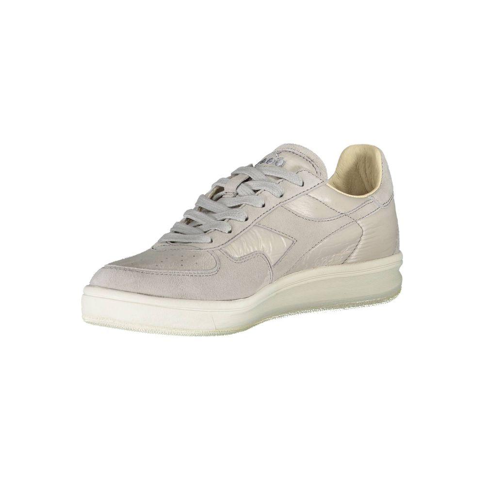 A single shoe against a white background. It is a low-top sneaker with a lace-up front and a flat sole. The shoe appears