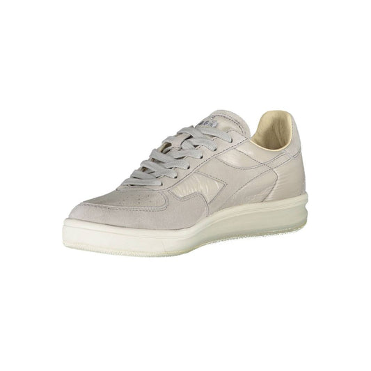 A single shoe against a white background. It is a low-top sneaker with a lace-up front and a flat sole. The shoe appears