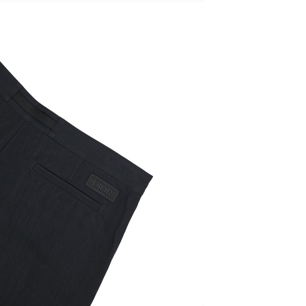 Pair of dark blue jeans with a visible logo on the right leg