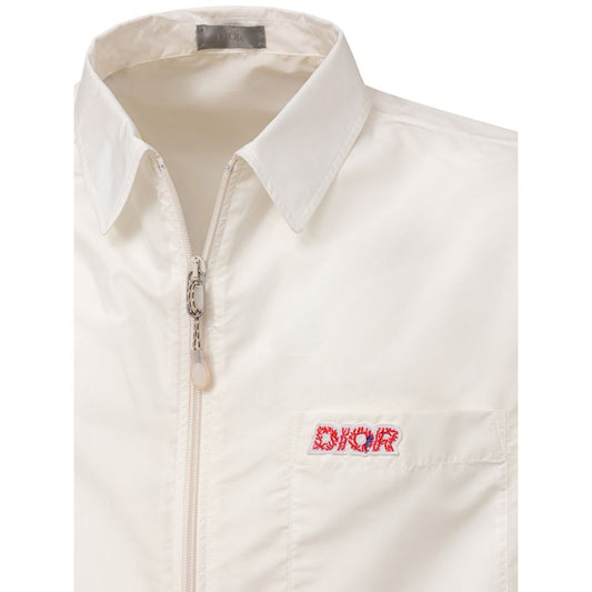 A white polyester shirt with a zippered front, short sleeves and a logo on the left chest
