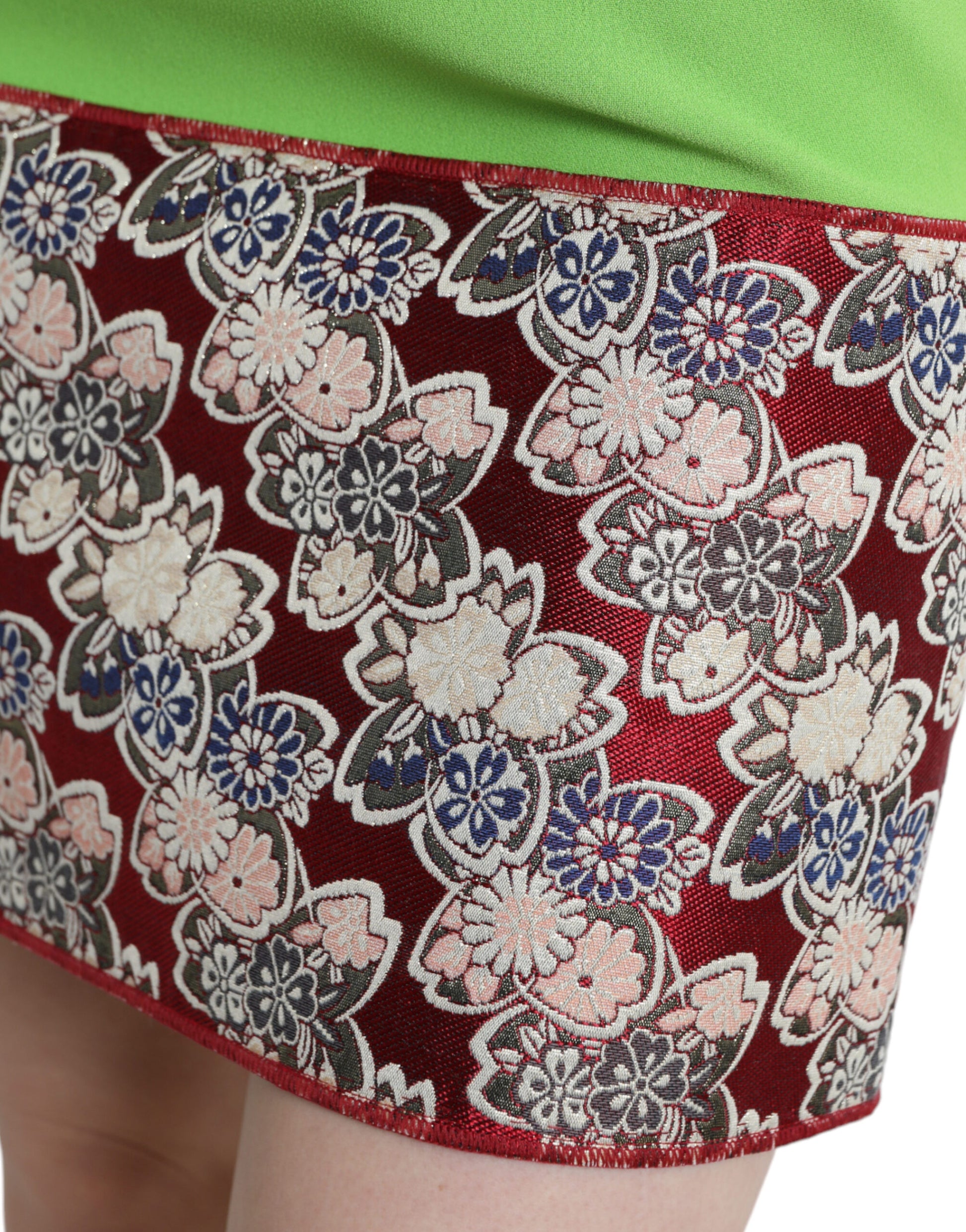A sleeveless dress with a floral pattern and red trim