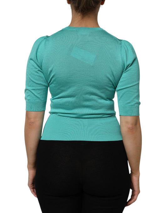 Woman wearing a green top and black pants