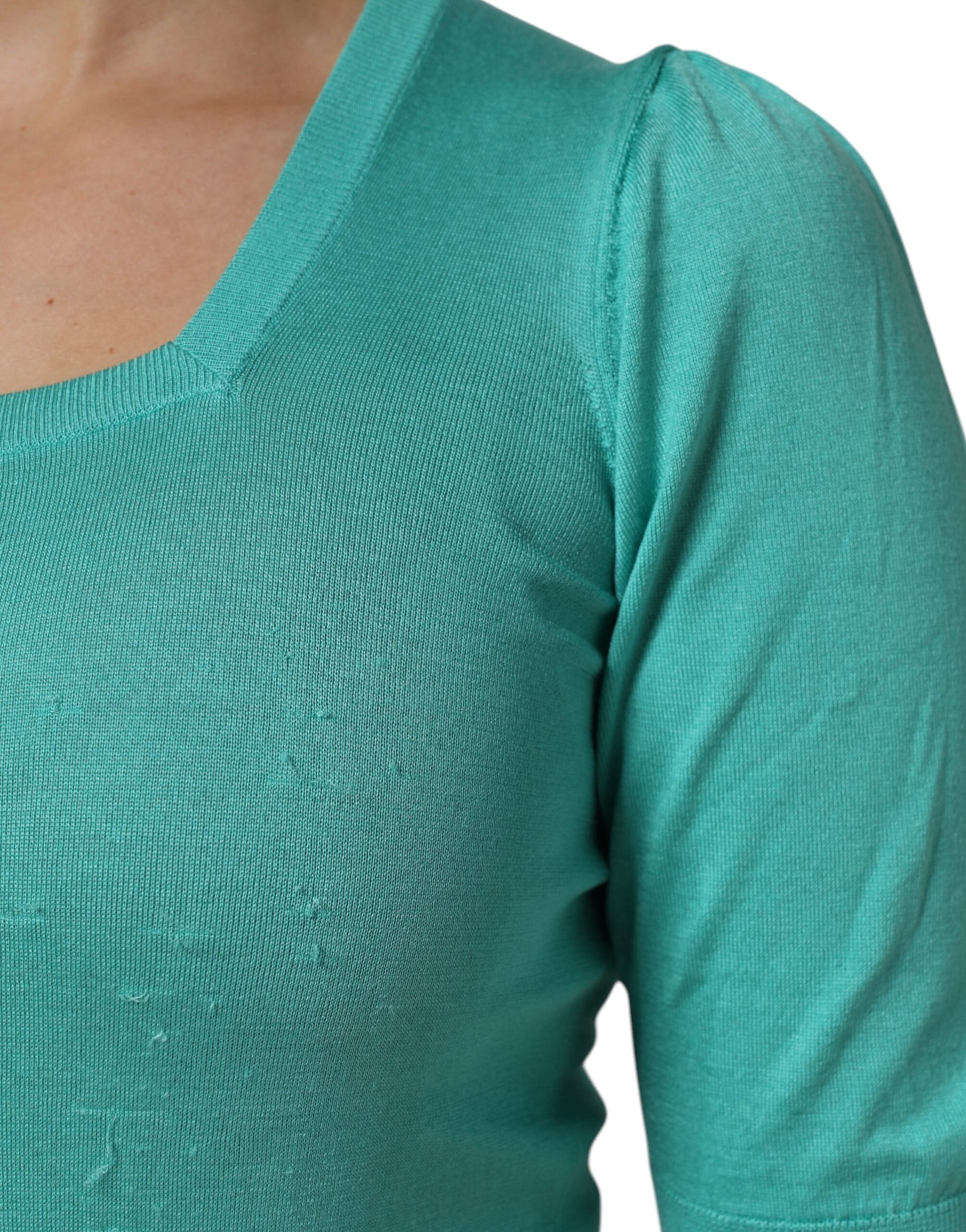 Long sleeve teal shirt on woman's torso
