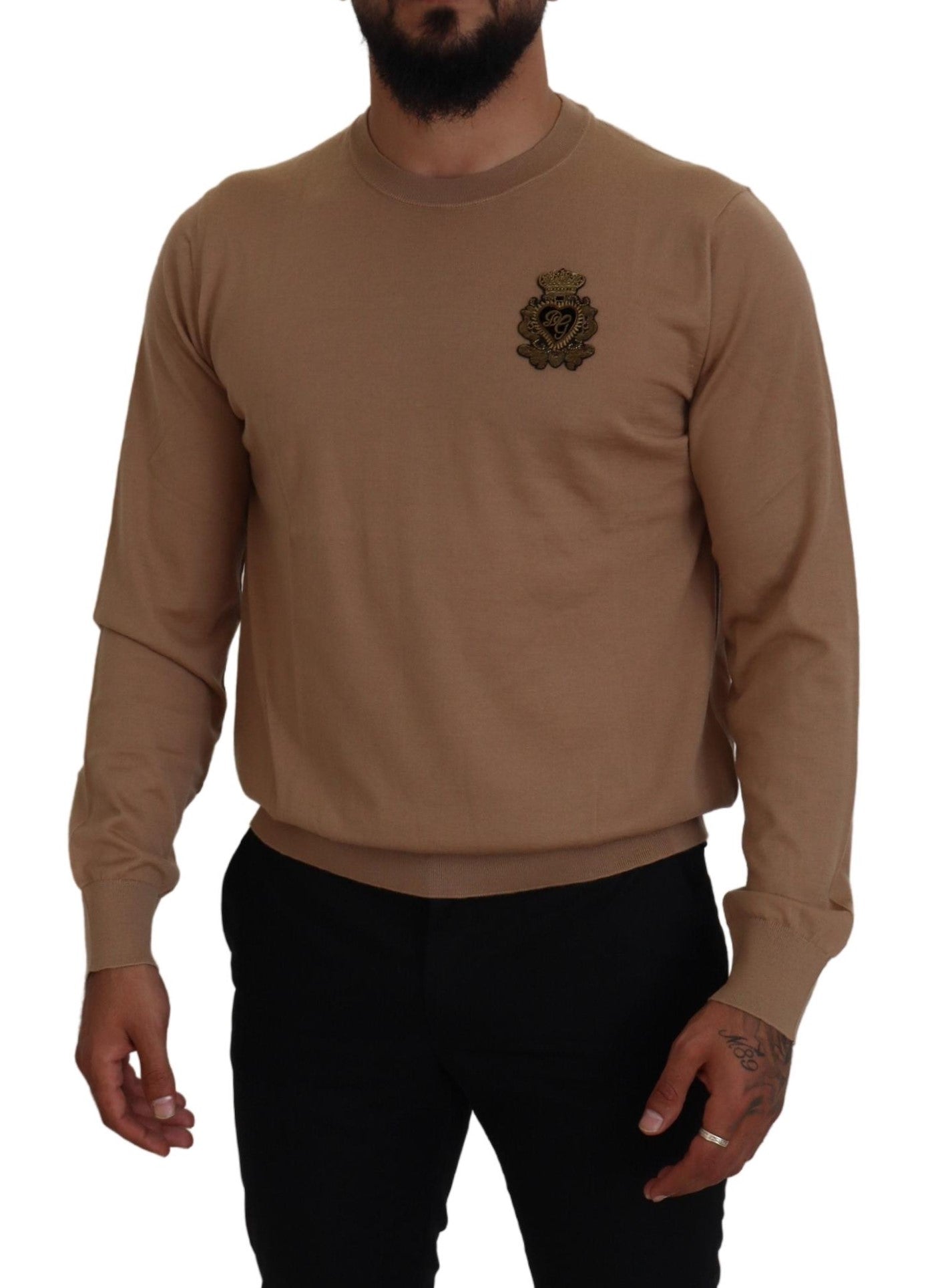 Man wearing long sleeve sweater with emblem on left chest