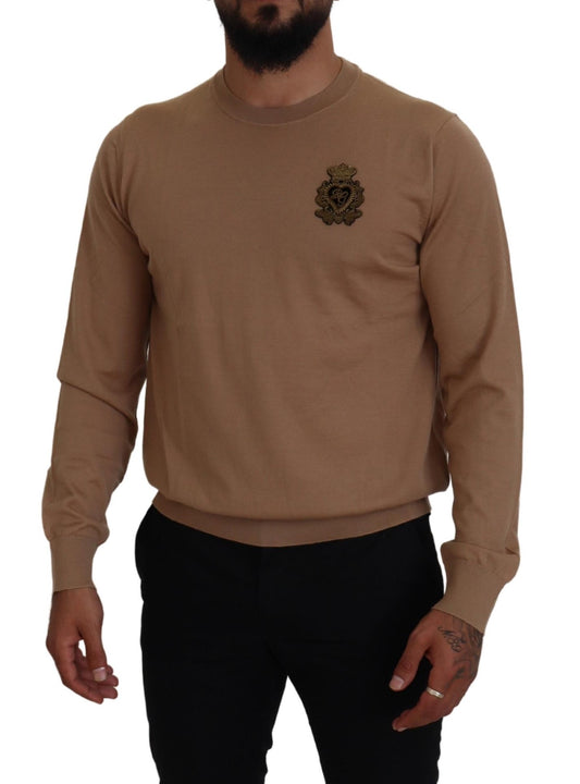 Man wearing long sleeve sweater with emblem on left chest